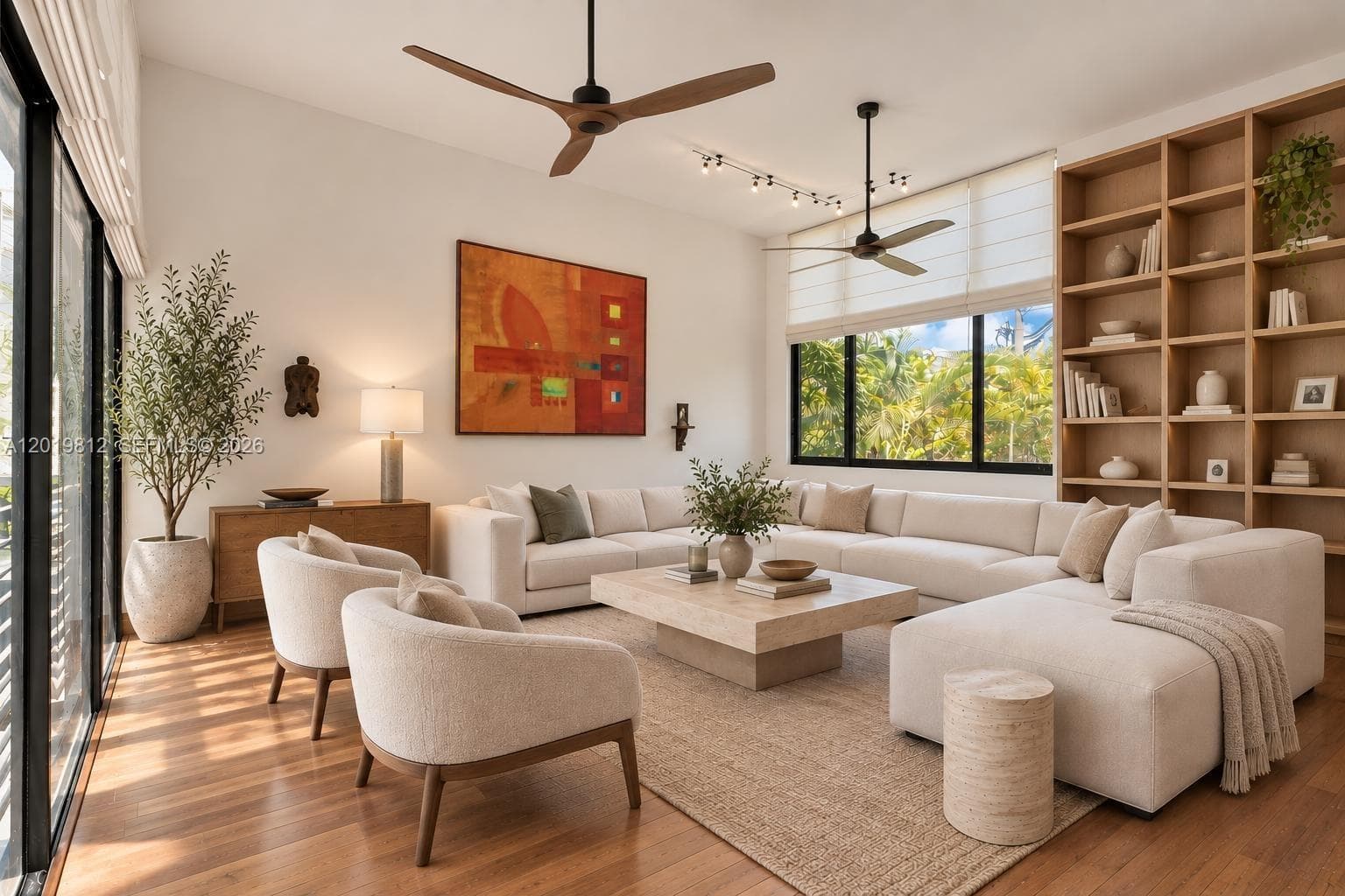 Living area featuring floor-to-ceiling windows with black frames, built-in floor-to-ceiling shelving, wood-finish flooring, and dual ceiling fans