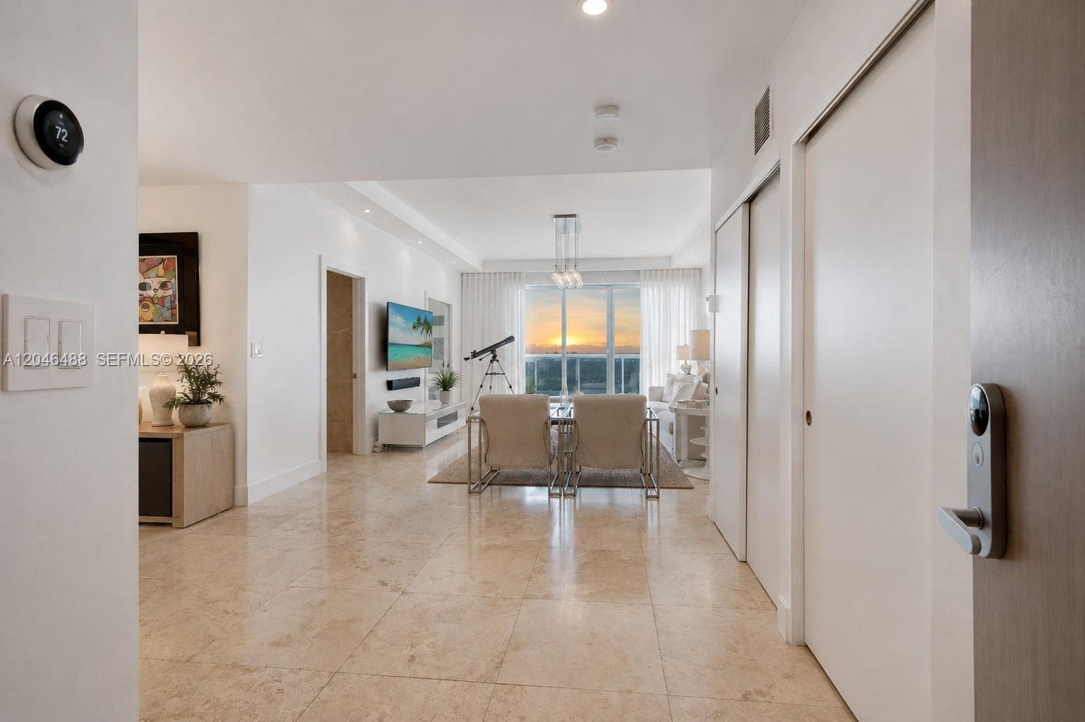 WHAT WAS VIRTUALLY STAGED:Added sheer curtains to the balcony windows, inspired by the natural, relaxed style of 1 Hotel South Beach.Updated the TV display with a Miami Beach/coastal image.Added and styled natural decorative accessories throughout the living area.Added greenery and organic decorative elements.Added a natural-texture area rug to complement the neutral interior.Styled the existing furniture with neutral accessories for a more cohesive luxury coastal look.Added decorative styling
