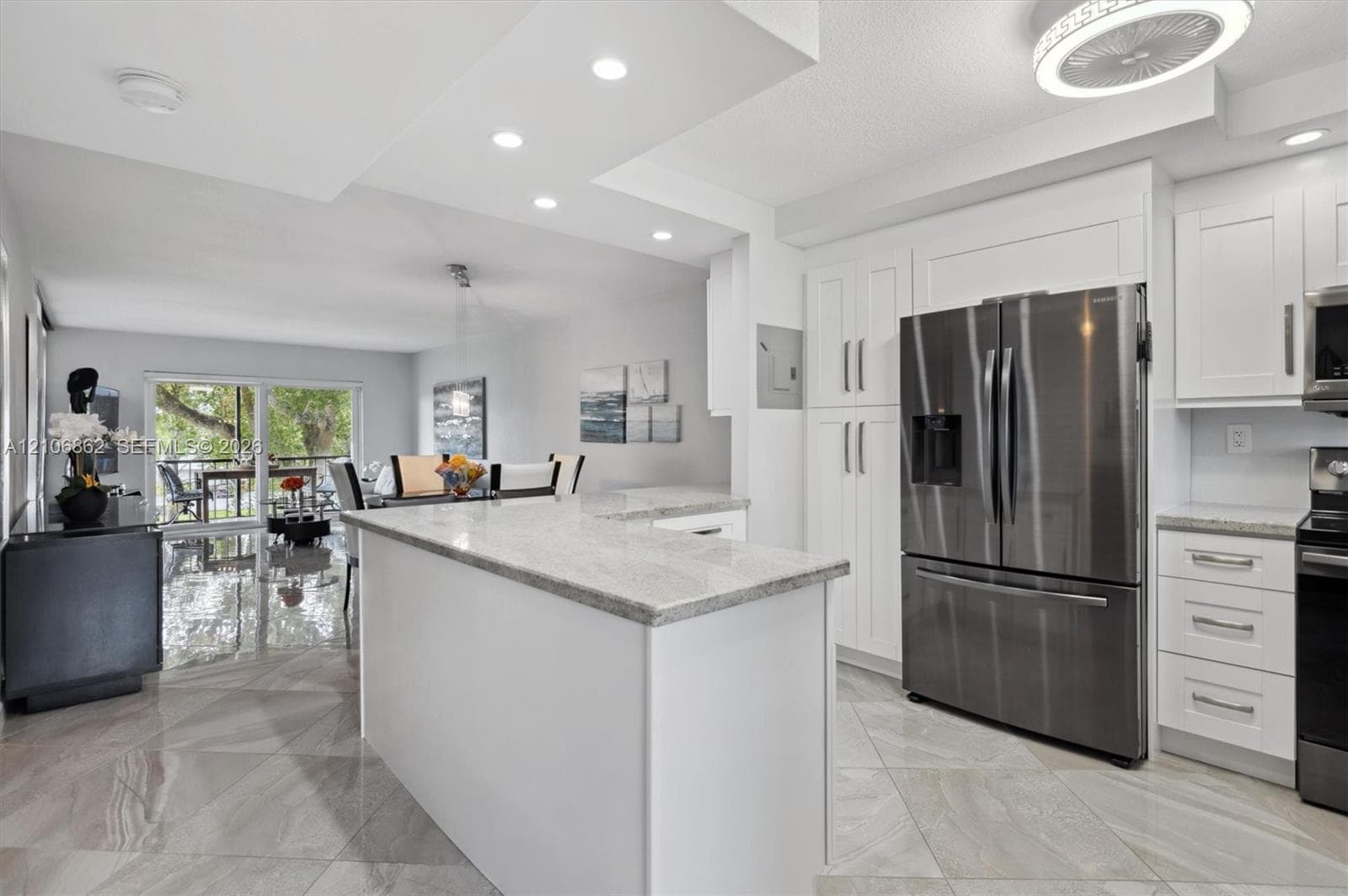 Kitchen featuring white cabinetry, stone countertops, stainless steel appliances, tile flooring, and recessed ceiling lighting